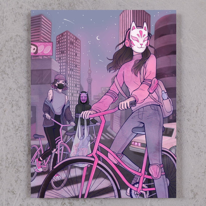 Three masked women on bicycles in a city